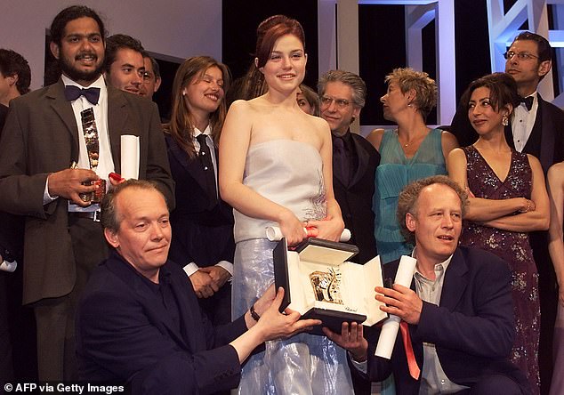 Belgian directors Luc (R) and Jean-Pierre Dardenne (R) and Belgian actress Emilie Dequenne (C) pose with the Palme d'or they received for their movie